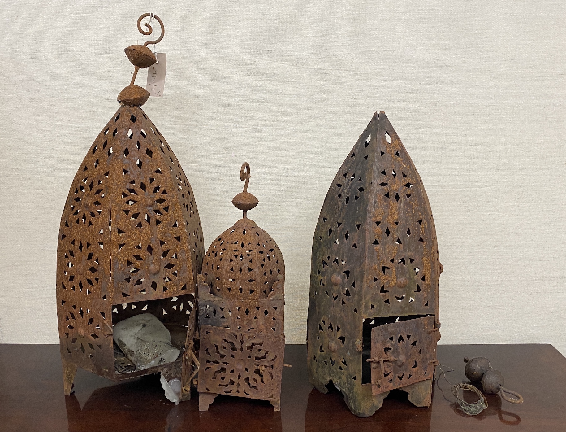 Three Moorish style weathered metal garden lanterns, largest height 60cm